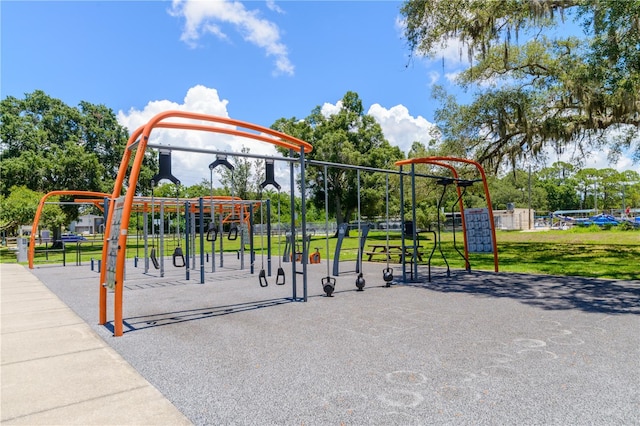 view of home's community featuring a playground and a yard