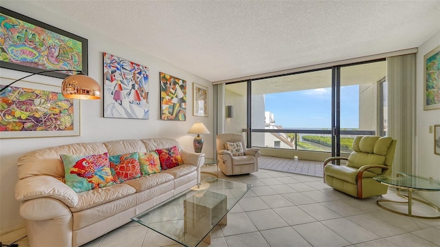 tiled living room with a wall of windows and a textured ceiling