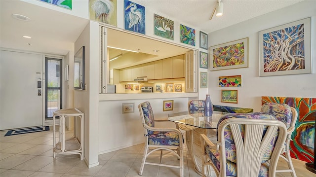 dining room with tile patterned flooring and a textured ceiling