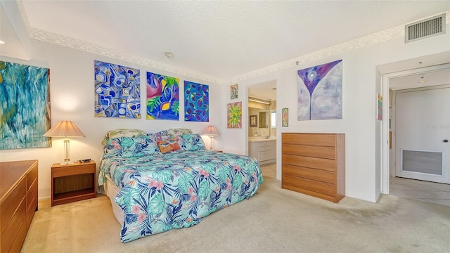 carpeted bedroom featuring a textured ceiling and connected bathroom