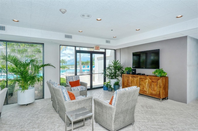 living room featuring french doors and plenty of natural light