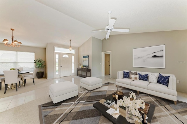 tiled living area with ceiling fan with notable chandelier and vaulted ceiling