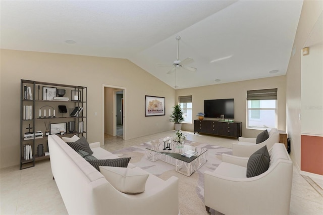 living room with light tile patterned floors, a healthy amount of sunlight, ceiling fan, and vaulted ceiling