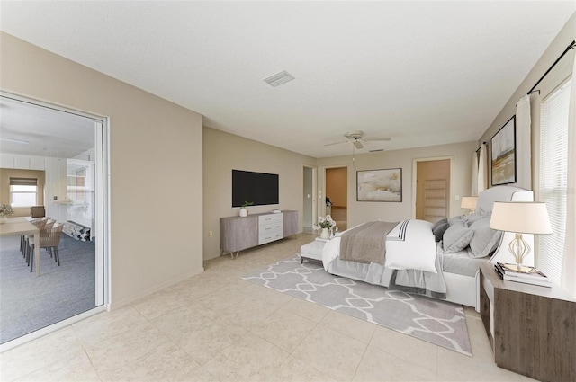 bedroom featuring light tile patterned floors, visible vents, and ceiling fan