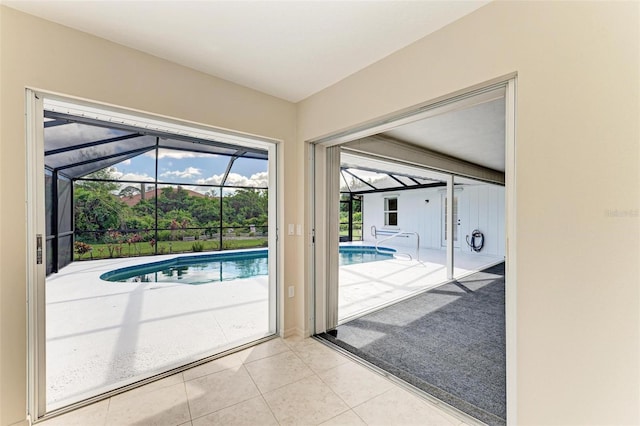 entryway featuring tile patterned floors, carpet, and a sunroom