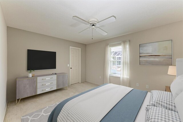 bedroom featuring light colored carpet and ceiling fan