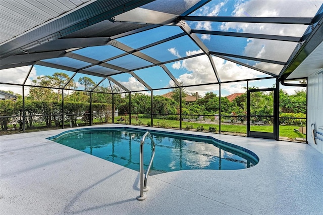 pool with glass enclosure and a patio