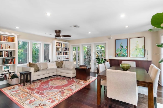 living room with ceiling fan, dark wood-type flooring, and a wealth of natural light