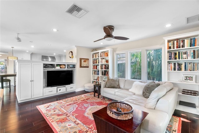 living room with dark hardwood / wood-style floors and ceiling fan