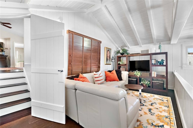 living room featuring ceiling fan, dark hardwood / wood-style flooring, lofted ceiling with beams, and wood walls