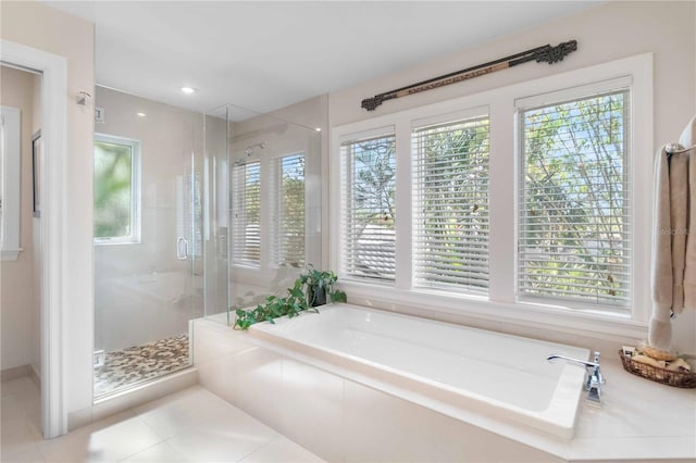 bathroom featuring tile patterned floors and separate shower and tub