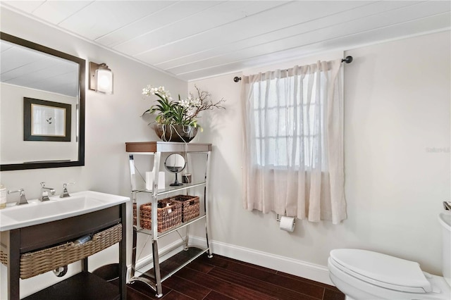 bathroom featuring toilet, vanity, and hardwood / wood-style flooring