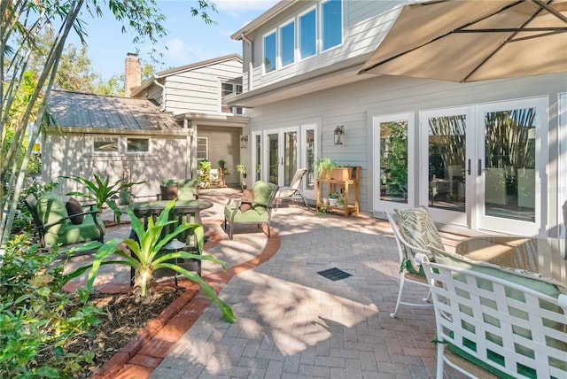 view of patio featuring an outbuilding and french doors