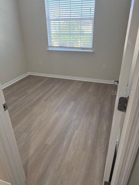 spare room featuring dark hardwood / wood-style flooring