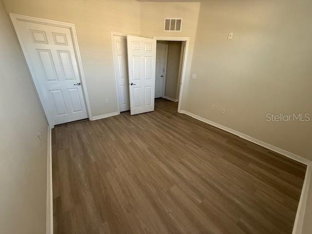 unfurnished bedroom featuring dark wood-type flooring