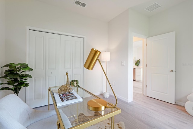 home office with light hardwood / wood-style flooring