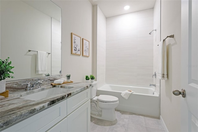 full bathroom featuring vanity, tiled shower / bath combo, and toilet