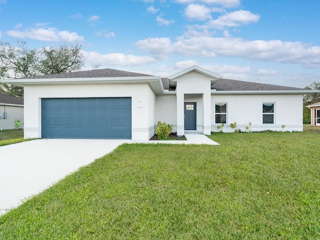 view of front of property with a front lawn and a garage