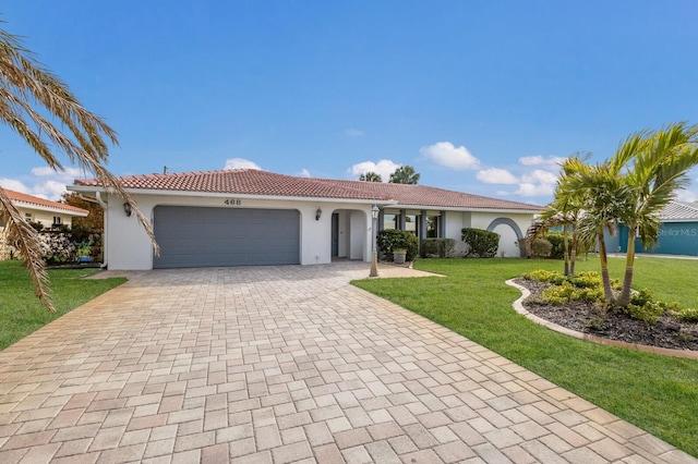 view of front facade with a front yard and a garage