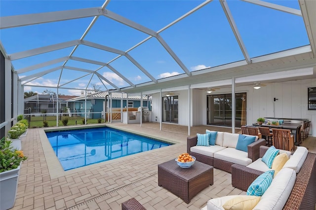 view of pool featuring glass enclosure, a hot tub, ceiling fan, outdoor lounge area, and a patio