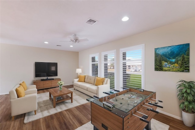 living room featuring ceiling fan and light hardwood / wood-style floors