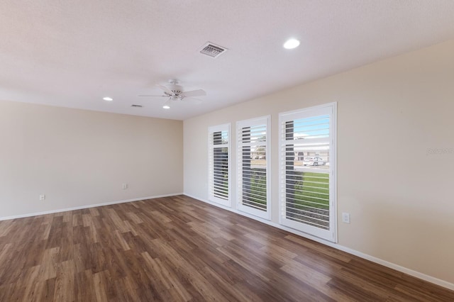 spare room featuring ceiling fan and dark hardwood / wood-style flooring