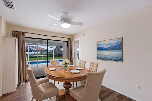 dining space with ceiling fan and hardwood / wood-style floors