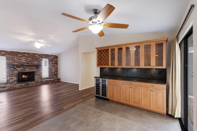 kitchen with ceiling fan, tasteful backsplash, lofted ceiling, a fireplace, and wine cooler