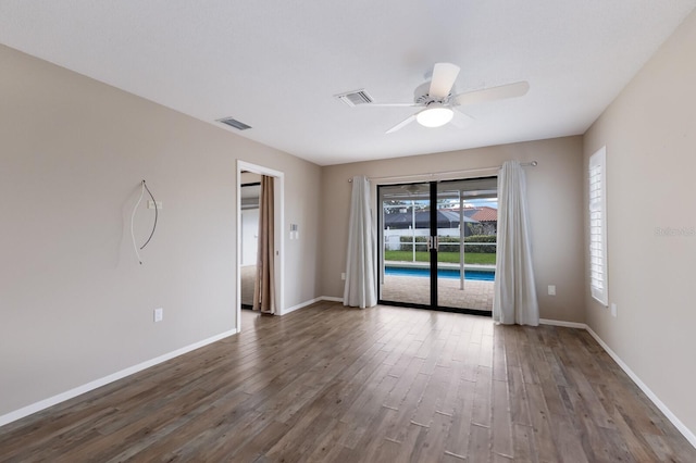 spare room featuring ceiling fan and dark hardwood / wood-style flooring