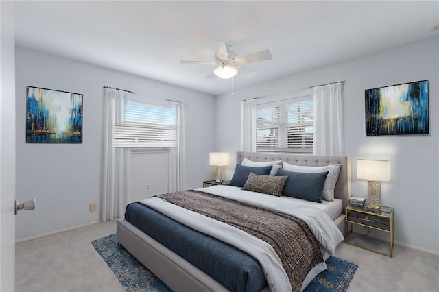 bedroom with ceiling fan and light colored carpet