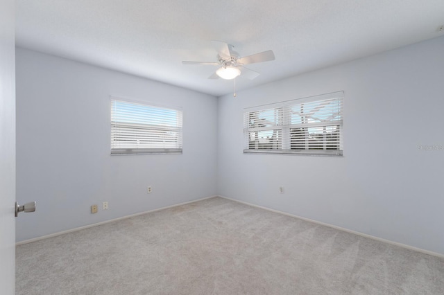 unfurnished room featuring light carpet and ceiling fan