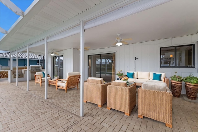 view of patio with ceiling fan, an outdoor living space, and area for grilling