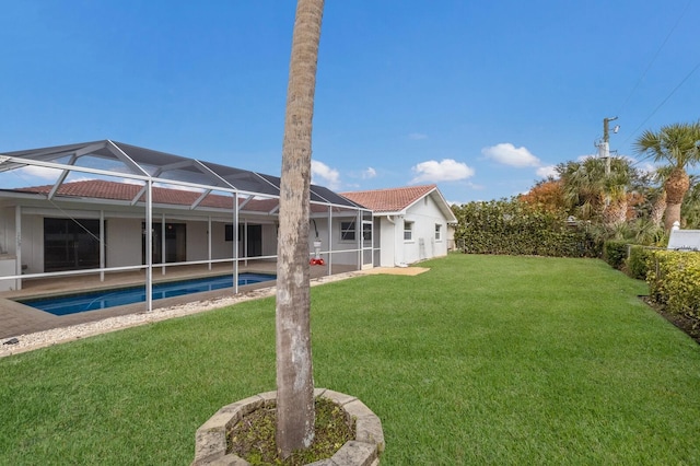 view of yard with glass enclosure and a fenced in pool