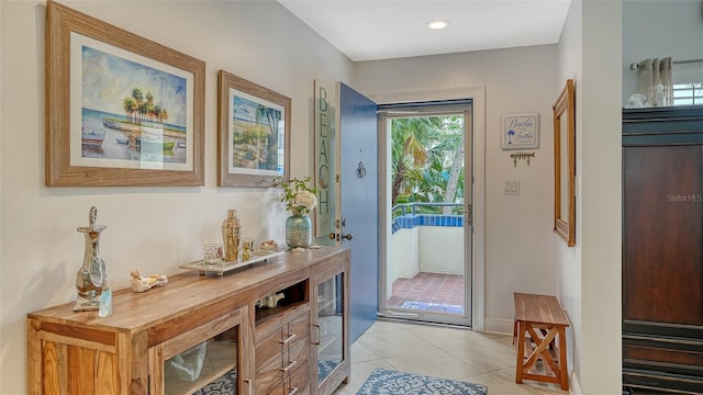 doorway with light tile patterned floors