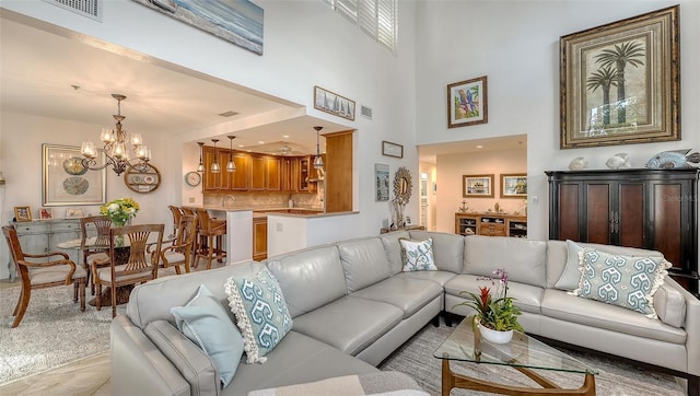 living room with a chandelier and a high ceiling