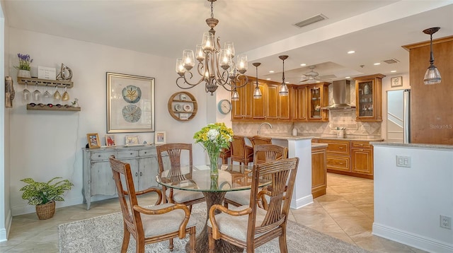 tiled dining space with sink and an inviting chandelier