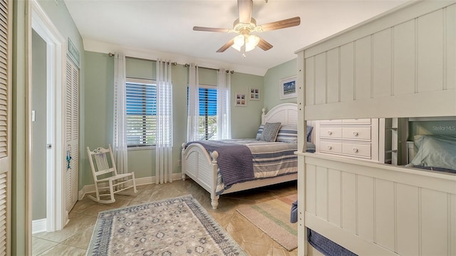 bedroom with light tile patterned floors and ceiling fan