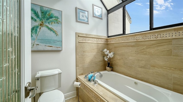 bathroom featuring a relaxing tiled tub and toilet