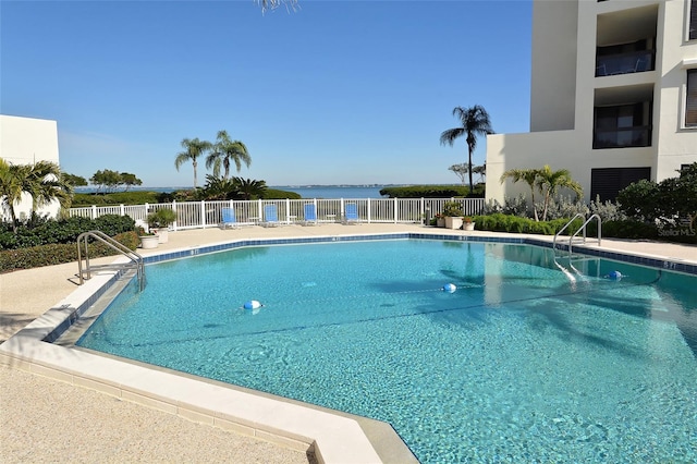 view of swimming pool featuring a water view