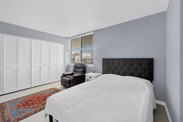 tiled bedroom with a closet