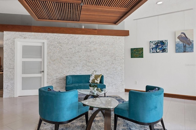 living area featuring light tile patterned flooring and wooden ceiling