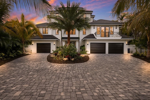 view of front of home featuring a balcony and a garage