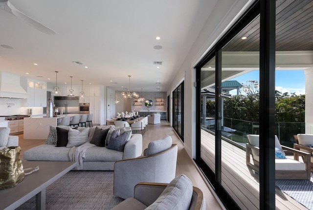 living room with a chandelier and light hardwood / wood-style flooring