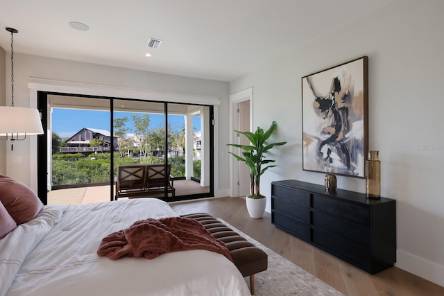 bedroom with light wood-type flooring and access to outside