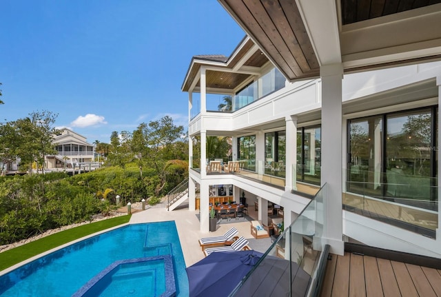 view of swimming pool featuring an in ground hot tub and a patio