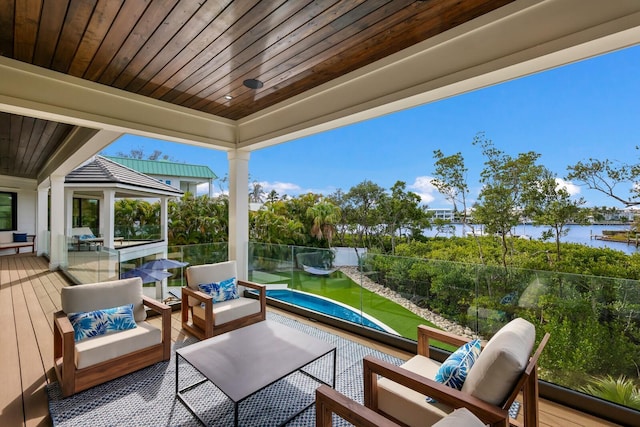 view of patio / terrace featuring outdoor lounge area and a deck with water view