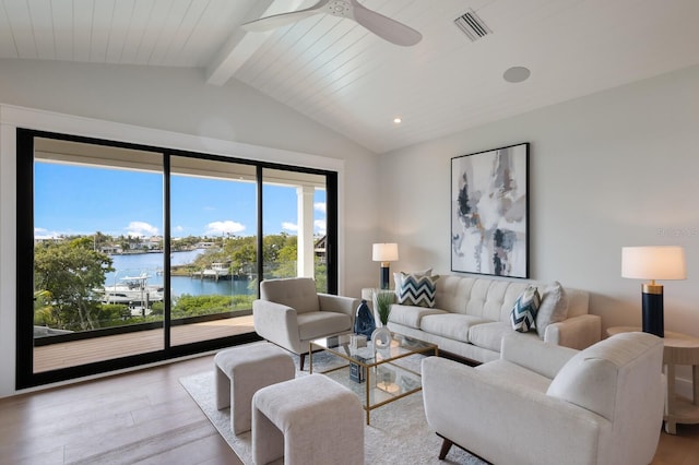 living room with a water view, vaulted ceiling with beams, ceiling fan, light wood-type flooring, and wood ceiling