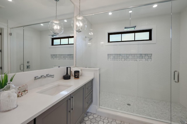 bathroom with vanity and a shower with door