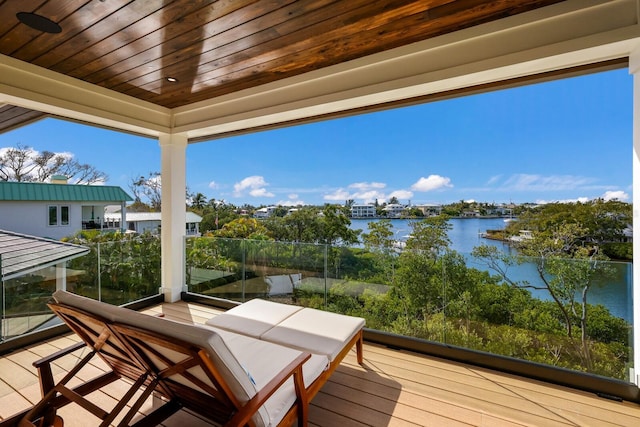 wooden terrace featuring a water view