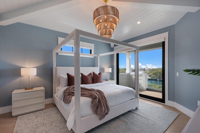 bedroom with beam ceiling, a water view, light wood-type flooring, and wooden ceiling